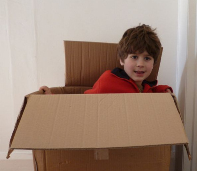 Boy getting out of a box