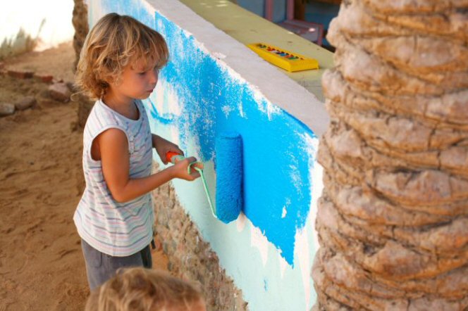 Child painting a wall