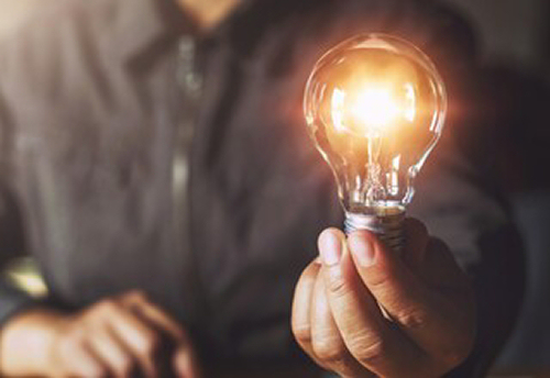 Person holding a lightbub